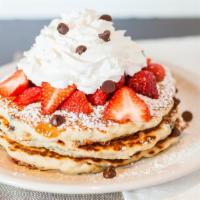 Strawberries Delight · Chocolate chip pancakes, topped with powdered sugar, fresh strawberries, and whipped cream