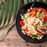 Papaya Salad · Green papaya with lemon juice, tomatoes, carrots and green beans.