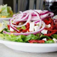 Greek · Mixed greens topped with kalamata olives, red & green peppers, red onions, feta cheese, sun-...