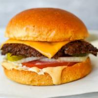 Smash Cheeseburger · Juicy, grilled beef burger smashed to perfection with American cheese, fresh shredded lettuc...