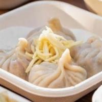 Xiao Long Bao · Juicy Dumpling with Plant Based Protein, Ginger, and Scallions. Served with Black Vinegar & ...
