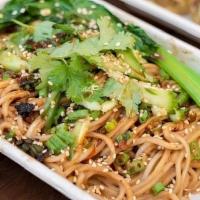 Dan Dan Noodles · Noodles tossed in Sesame Sauce. Topped with Plant Based Meat, Cilantro, and Pickled Cucumbers.