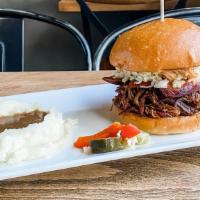 The Texan · Chopped and sauced brisket, hot link, coleslaw, house pickles, bun.  (NOTE: Spicy)