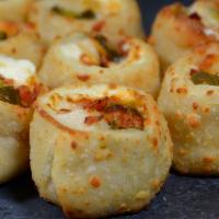 Jalapeño Poppers · Jalapeno peppers and mozzarella cheese baked in a puff pastry.