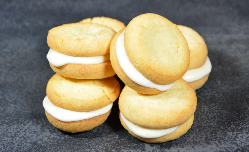 Sugar Cookie Sammies (5) · A layer of creamy cheesecake in between two bite sized sugar cookies. Includes 5 cookies.