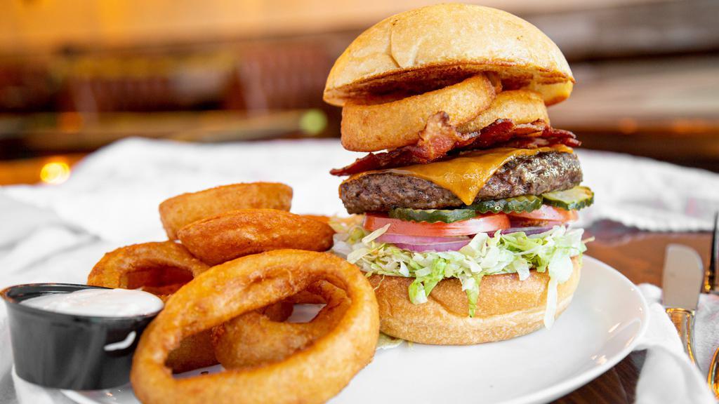 Western Bacon Cheeseburger · Charbroiled fresh 6 oz. chuck beef patty with BBQ sauce, mayo, lettuce, tomato, crispy bacon, beer-battered onion rings and cheddar cheese.