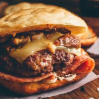 Cowboy Burger · Charbroiled fresh 6 oz. chuck beef patty with BBQ sauce, lettuce, tomato, sautéed onion, sau...