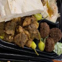 Dubai Mix Plate · Chicken shawarma and Lamb & Beef Gyro mixed with Green and Mango Sauce. It comes on a bed of...