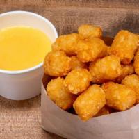 Cheese Tots · Crispy tater tots and cheddar cheese sauce.
