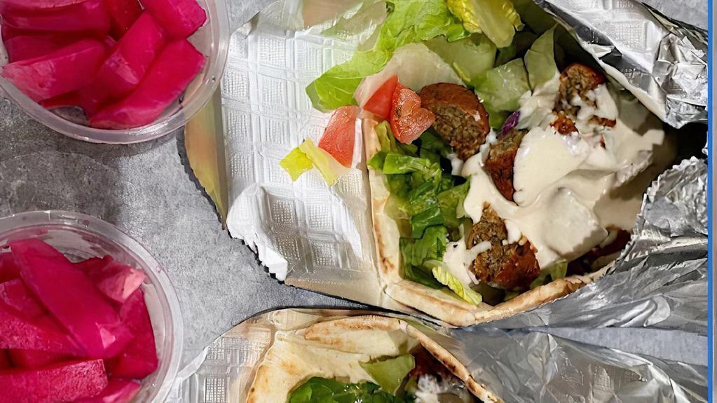 Falafel Wrap · Wrapped in pita bread with lettuce, tomatoes, red onions and tahini sauce.