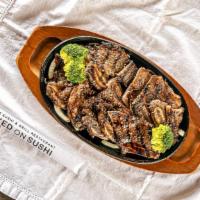 Bbq Short Ribs · Marinated beef short ribs over stir fried veggies