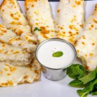 Cheesy Garlic Bread · Cheesy garlic bread sticks smothered with creamy white garlic sauce and topped with mozzarel...