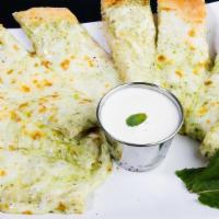 Creamy Pesto Bread · Cheesy garlic bread sticks smothered with creamy pesto sauce and topped with mozzarella chee...