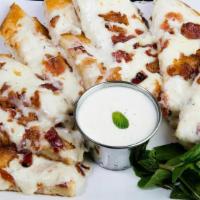 Cheesy Bacon Bread · Cheesy garlic bread sticks smothered with creamy white garlic sauce and topped with mozzarel...