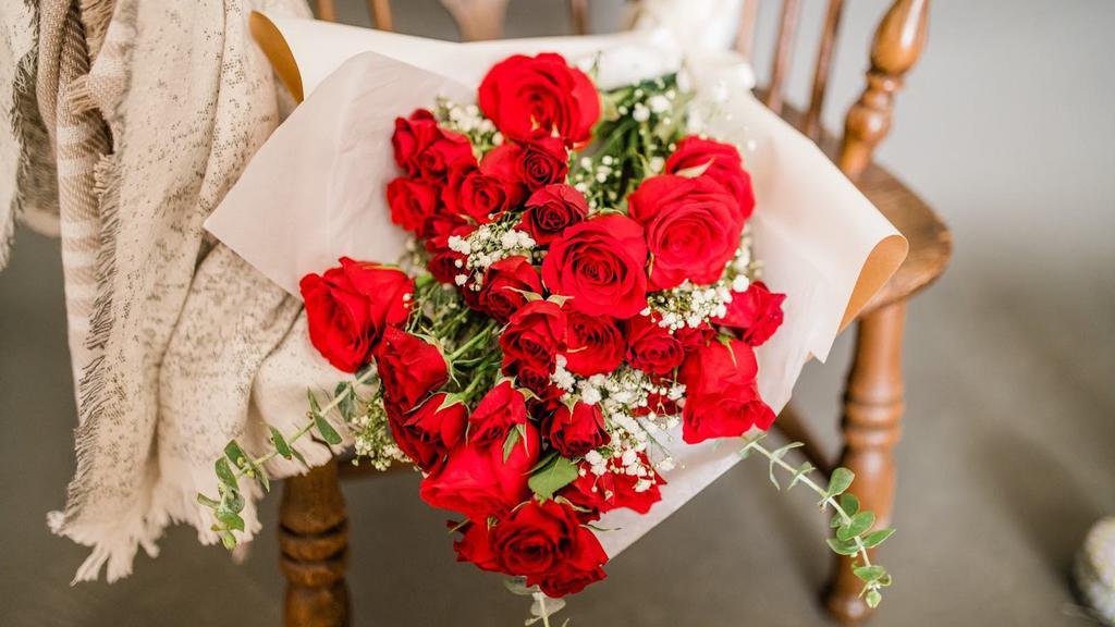 Red Rose Bouquet · 12 stunning red roses and mixed with dainty spray roses. This beautiful and timeless bouquet cannot be customized and is wrapped for your convenience. Image shows approximate size and style, design will vary based on availability of product.