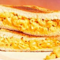 Mac And Cheese Melt Sandwich · Classic mac and cheese sandwiched between two slices of toasted white bread.
