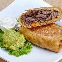 Chimichanga · Deep Fried burrito filled w/ rice, beans, cheese & cilantro. Side of sour cream & guacamole.