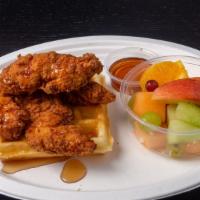Chicken Tender & Waffle · Belgian waffle cooked in cast iron with buttermilk fried chicken tenders with a side of syrup.