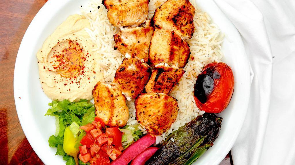 Chicken Kabab Plate · Marinated chicken  served with rice, red onions, roasted tomato, pepper, hummus, lettuce salad, pickles and pita bread.