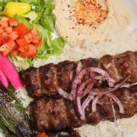 Lule Kabab Plate · Served with ground beef, rice, red onions, roasted tomato, pepper, hummus, lettuce salad, pi...