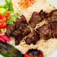 Beef Kabab Plate · Marinated beef served with rice, red onions, roasted tomato, pepper, pickles, hummus, lettuc...
