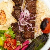 Beef Combo Plate · Marinated beef shish kebab and beef  lule kebab served with rice, red onions, roasted tomato...