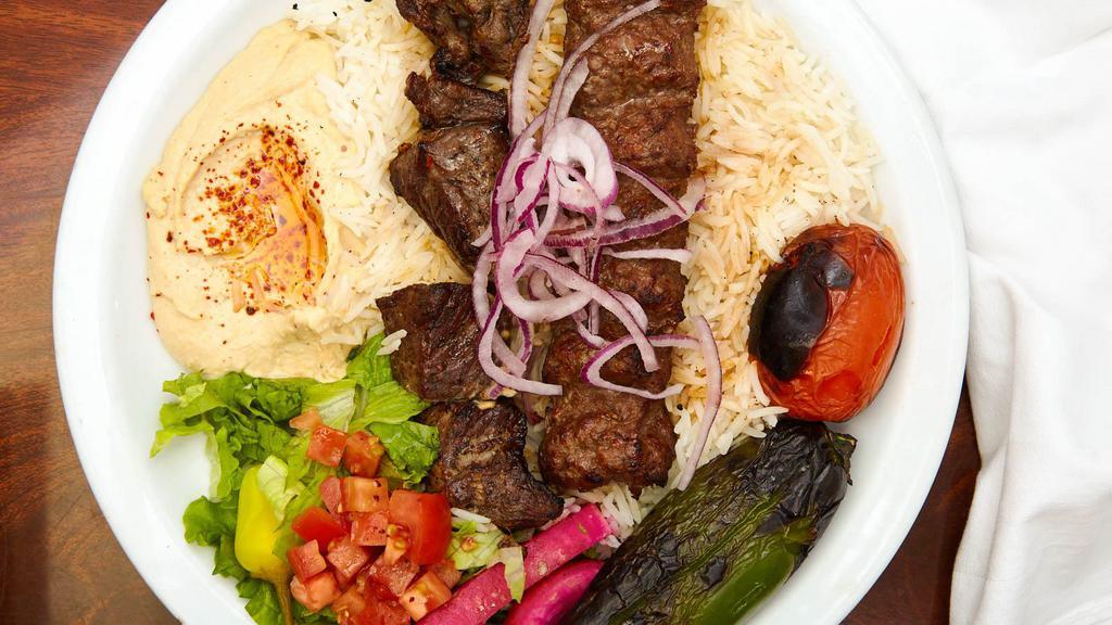 Beef Combo Plate · Marinated beef shish kebab and beef  lule kebab served with rice, red onions, roasted tomato, pepper, pickles, hummus, lettuce salad and pita bread.