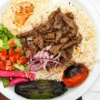Beef  Shawerma Plate · Marinated beef shawerma strips served with hummus, tahini sauce, tomato, lettuce red onions,...