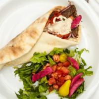 Beef Shawerma Wrap · Served with marinated beef shawerma strips wrapped in pita bread with tomatoes, lettuce, oni...