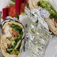 Chicken Shawerma Wrap · Marinated chicken shawerma strips wrapped in pita bread with tomatoes, lettuce, onion and ga...