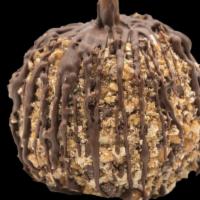 Snickers Caramel Apple · A granny smith apple covered in fresh caramel, rolled in tiger butter (a mixture of peanut b...