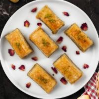Baklava  · (Two pieces) Phyllo dough and almonds or pistachio depending on availability.