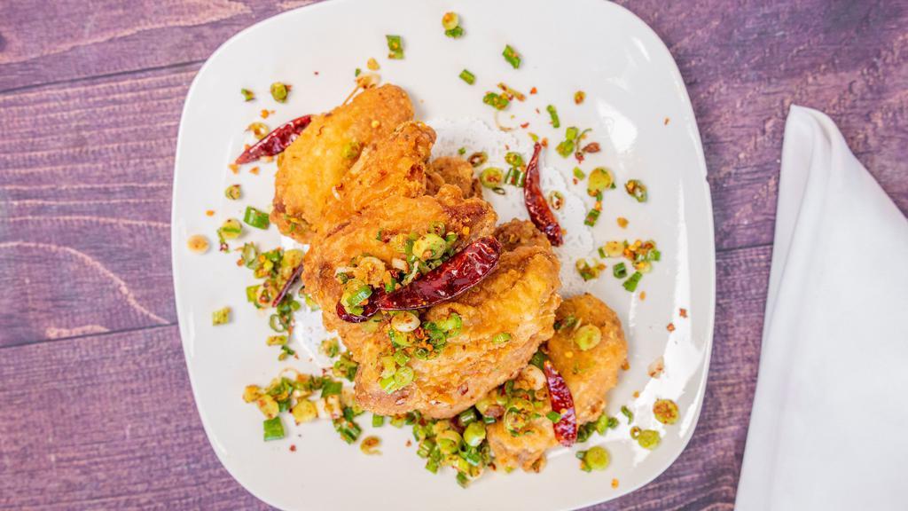 Salt Pepper Wings · Hot and spicy. Deep-fried wings with green onion and chili flakes.
