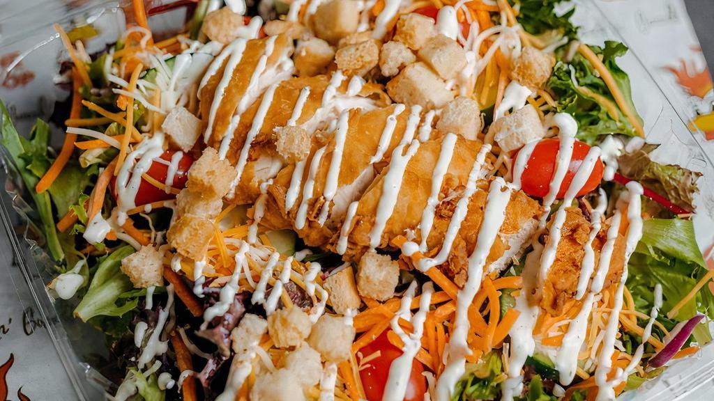 Crispy Chicken Salad · Fresh spring mix, shredded carrots, cherry tomatoes, cucumbers, shredded cheese, crispy chicken, choice of dressing, croutons.