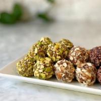 Cacao Truffles · Raw cacao cashew butter truffle rolled in nuts and superfoods.