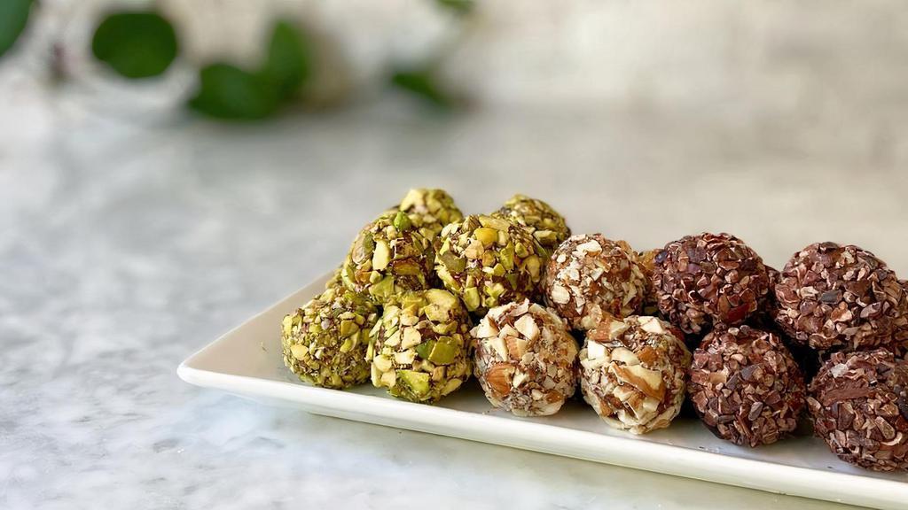 Cacao Truffles · Raw cacao cashew butter truffle rolled in nuts and superfoods.