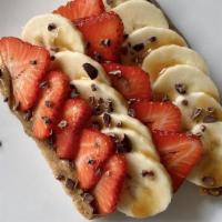 Almond Butter Toast · Fresh made almond butter, strawberries, banana, cacao nibs, maple syrup. gluten free bread.