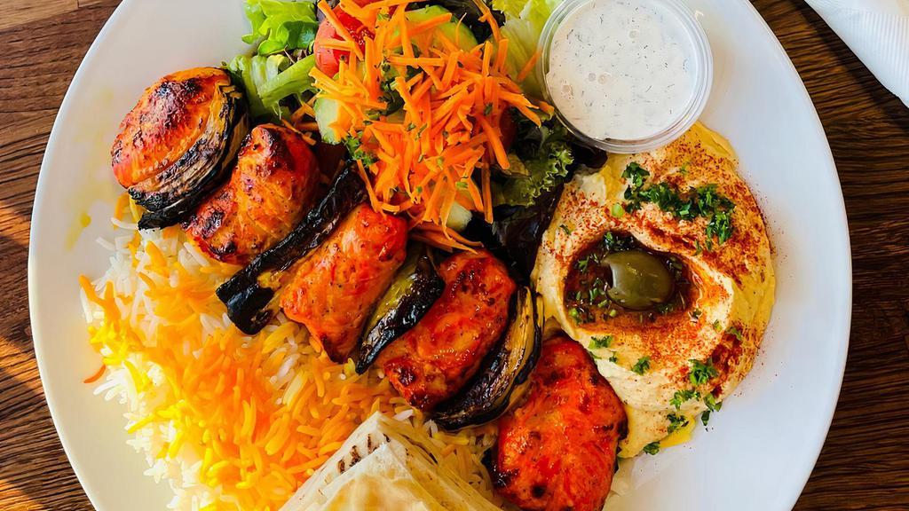 Chicken Kabob Plate · Gluten free. Grilled chicken breast marinated in lemon juice and saffron, with bell peppers and onion. Served with white or brown rice, salad, and hummus.