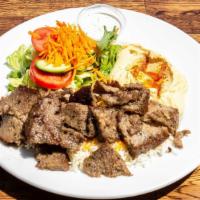 Lamb Gyro Plate · Gluten free. Ground lamb and beef slowly cooked on a vertical rotisserie. Served with white ...