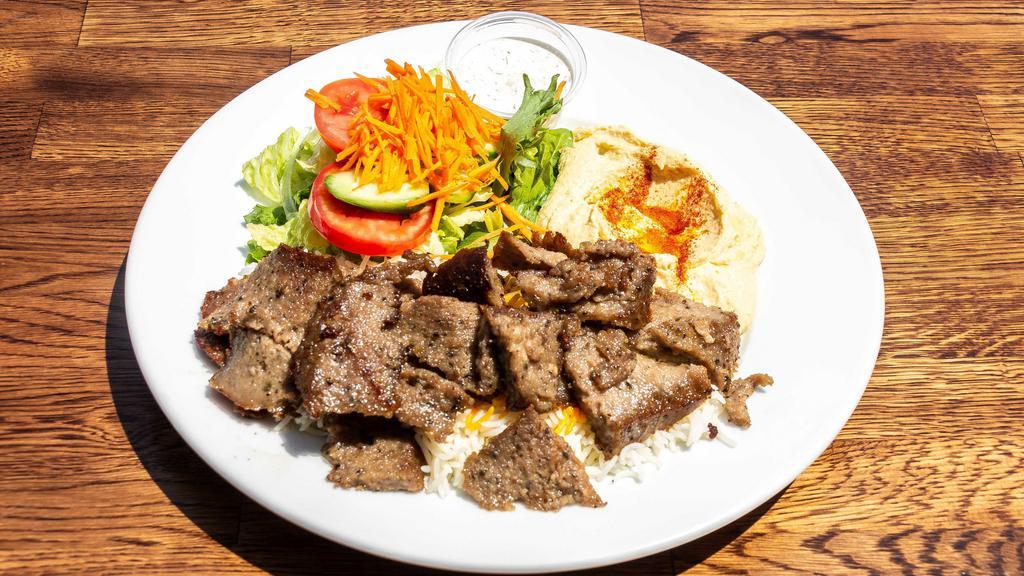 Lamb Gyro Plate · Gluten free. Ground lamb and beef slowly cooked on a vertical rotisserie. Served with white or brown rice, salad, and hummus.