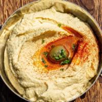 Hummus · Vegetarian, gluten free. Puréed chickpeas topped with paprika and olive oil. Served with pit...