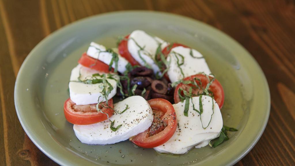 Caprese · Sliced organic fresh tomatoes, topped with fresh mozzarella cheese and basil.