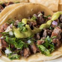 Carne Asada Tacos · (4 tacos) carne asada, corn tortillas, cilantro, onions, avocado crema served with chips and...