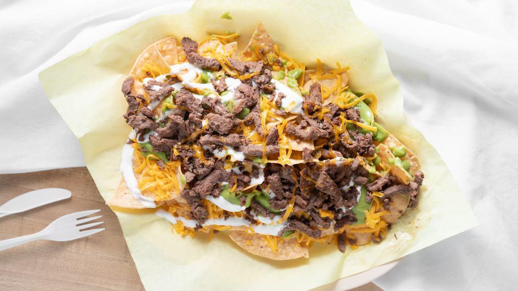 Super Nachos · Your choice of meat With guacamole, sour cream, and cheese.