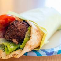 Falafel · Vegetarian sandwich of falafel with Romaine lettuce, tomatoes, Hummus, & pickles in pita bre...