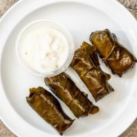Dolmades · Four pieces. Lemon rice wrapped in grape leaves.