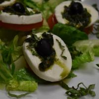 Insalata Caprese · Bed of greens, buffalo mozzarella, tomato, fresh basil and black pepper.