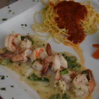 Scampi Al Limone · Large shrimp sauteed in lemon wine caper sauce. Served with a side of pasta marinara and mix...