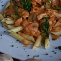 Penne Sinatra · Pasta, chicken, spinach and mushrooms in a blush pink rose sauce.