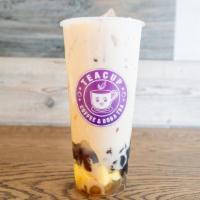 Tea Party Milk Tea · Teacup Milk Tea topped with boba, egg pudding, lychee jelly, red bean, and herbal jelly.